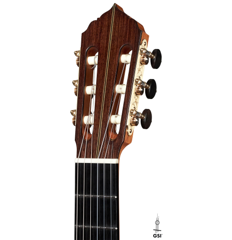 The headstock of a 2023 Amélie Bouvret classical guitar made of cedar and figured mahogany.