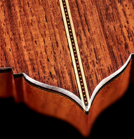The headstock of a 2023 Amélie Bouvret classical guitar made of cedar and figured mahogany.