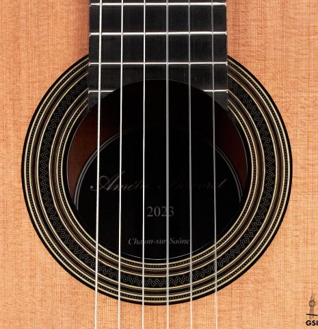 The rosette of a 2023 Amélie Bouvret classical guitar made of cedar and figured mahogany.