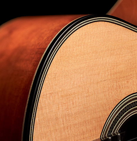 The soundboard and sides of a 2023 Amélie Bouvret classical guitar made of cedar and figured mahogany.