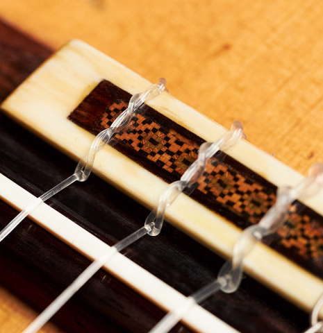 The tie block of a 1957 Robert Bouchet classical guitar made with spruce and CSA rosewood.