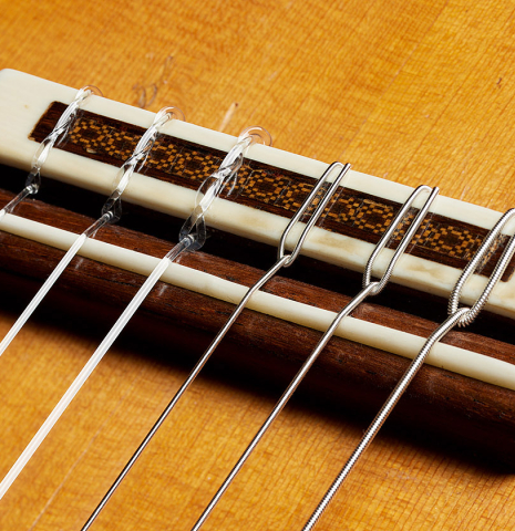 The bridge, tie-block and saddle of a 1965 Robert Bouchet classical guitar made of spruce and CSA rosewood