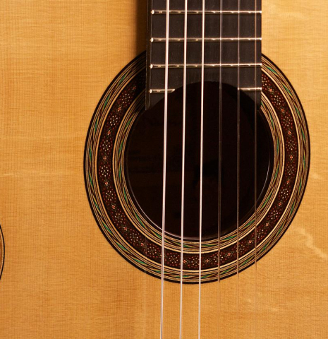 The soundboard and rosette of the 2012 Tobias Braun classical guitar made with bearclaw German spruce and satinwood.