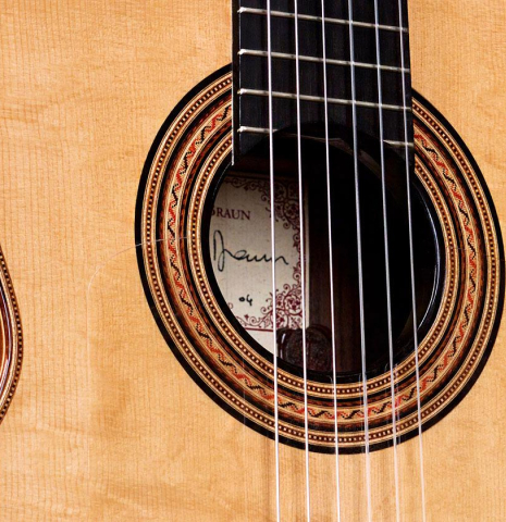 The soundboard and rosette of a 2004 Tobias Braun "1912 Ramirez" made of spruce and Indian rosewood