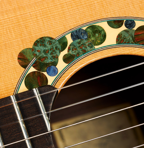 The soundboard and rosette of a 2019 Greg Brandt classical guitar made of cedar and CSA rosewood