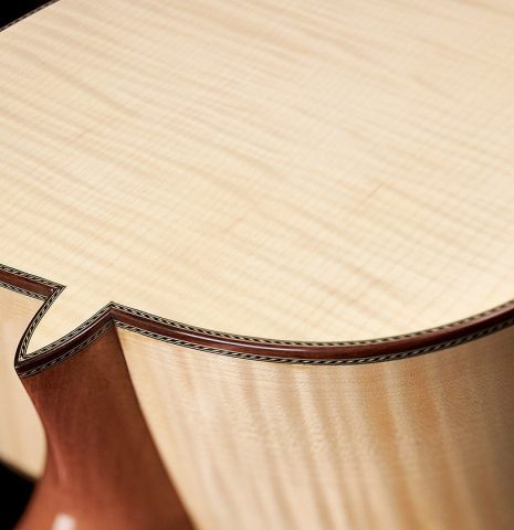 The back and heel of a 2023 Kenneth Brogger classical guitar made of spruce and maple.