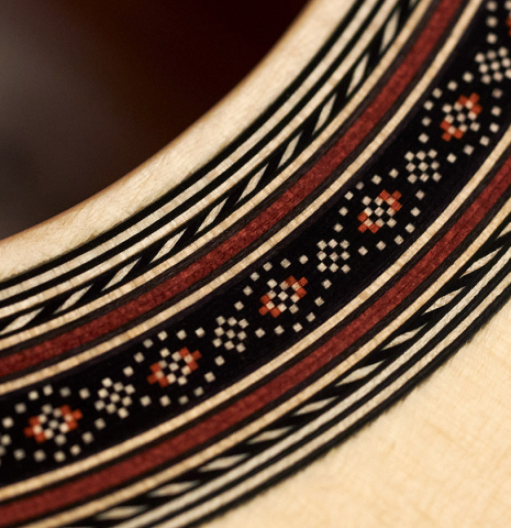 The rosette of a 2023 Kenneth Brogger classical guitar made of spruce and maple.