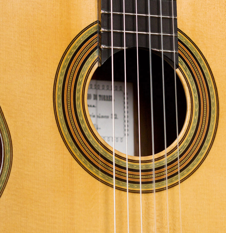 The top and rosette of a 2021 Kenneth Brogger "1864 Torres" classical guitar made of spruce and CSA rosewood