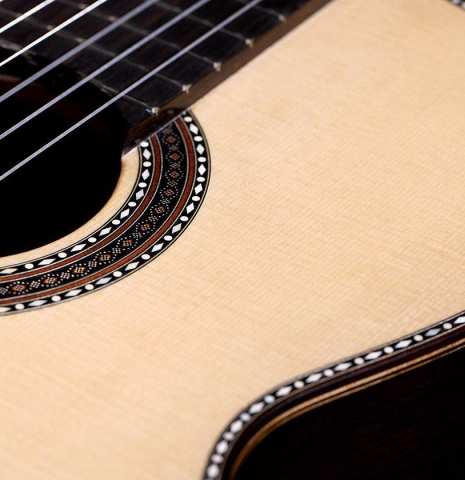 The soundboard and rosette of a 2020 Kenneth Brogger "Stradivarius" classical guitar made of spruce and CSA rosewood