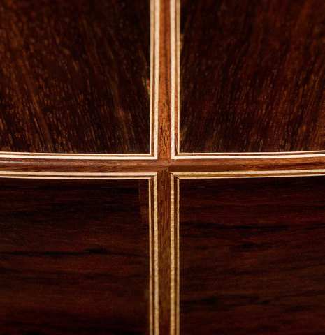 The back and sides at the foot of a 2020 Kenneth Brogger "Stradivarius" classical guitar made of spruce and CSA rosewood