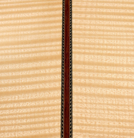 A close-up of the back of a 2008 Kenneth Brogger classical guitar made of spruce and maple