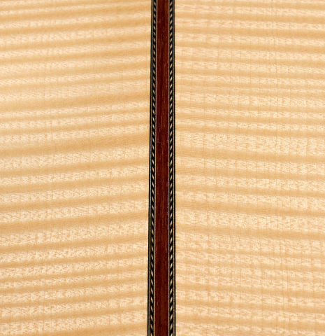 A close-up of the back of a 2008 Kenneth Brogger classical guitar made of spruce and maple