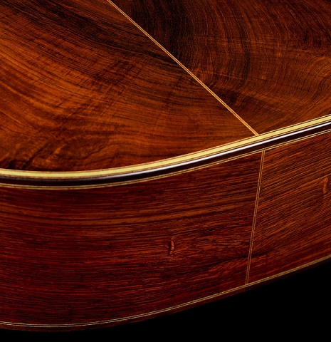 The back and sides at the foot of a 2009 Kenneth Brogger "1864 Torres" classical guitar made of spruce and CSA rosewood