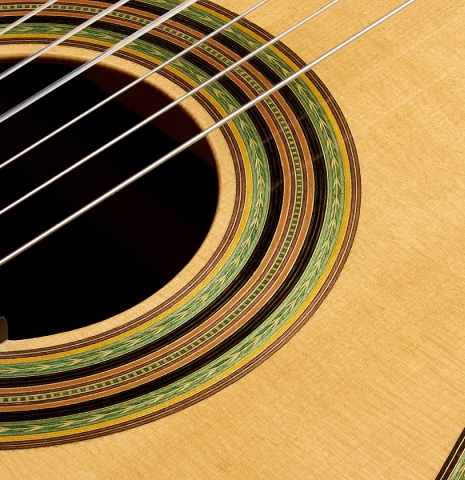 The top and rosette detail of a 2009 Kenneth Brogger "1864 Torres" classical guitar made of spruce and CSA rosewood