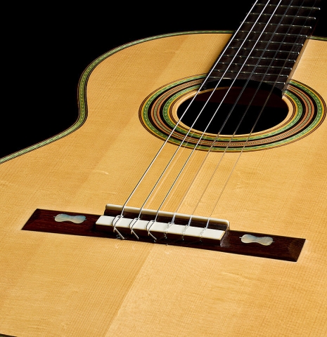 The sounboard and bridge of a 2009 Kenneth Brogger "1864 Torres" classical guitar made of spruce and CSA rosewood