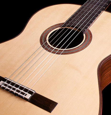 The soundboard and rosette of a 2007 Michel Bruck classical guitar made of spruce and CSA rosewood
