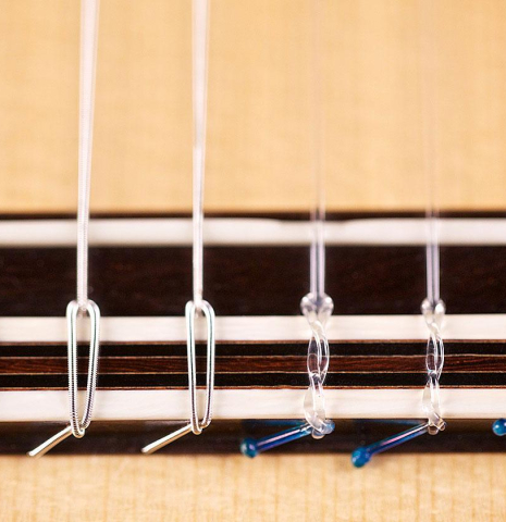 The bridge, tie-block and saddle of a 2007 Michel Bruck classical guitar made of spruce and CSA rosewood