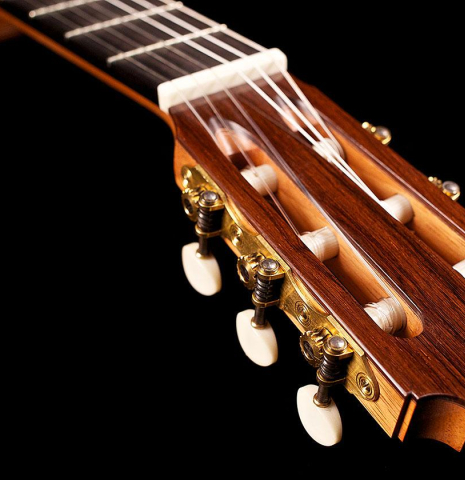 The headstock and tuning machines of a 2007 Michel Bruck classical guitar made of spruce and CSA rosewood