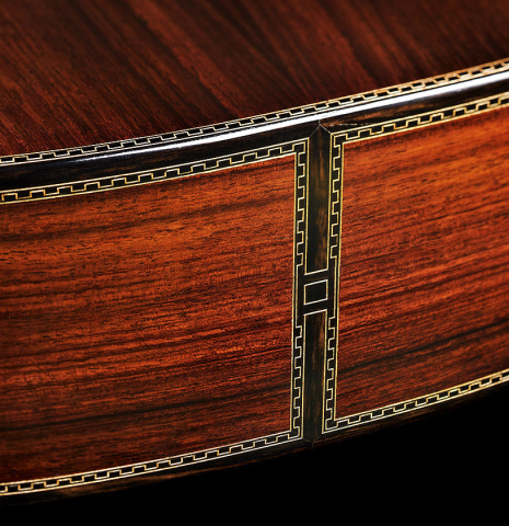 The back, sides and purflings at the foot of a 2023 Ivan Bruna "Limited Edition" classical guitar made of spruce and Indian rosewood