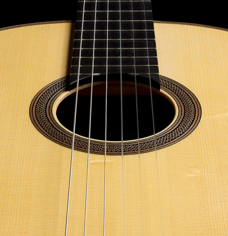 The soundboard and rosette of a 2025 Ivan Bruna classical guitar made of spruce and Indian rosewood
