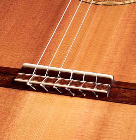 This is a close-up of the bridge, tie-block and saddle of a 1984 Cynthia H. Burton CD/IN classical guitar