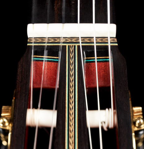A close-up of the headstock of a 2012 Geza Burghardt &quot;1943 Hauser&quot; classical guitar made with spruce and maple.