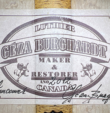 The label of a 2012 Geza Burghardt &quot;1943 Hauser&quot; classical guitar made with spruce and maple.