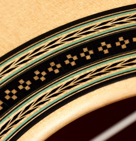 A close-up of the rosette of a 2012 Geza Burghardt &quot;1943 Hauser&quot; classical guitar made with spruce and maple.