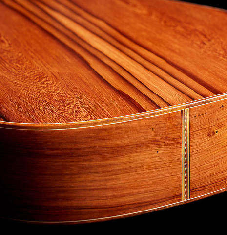 The back and sides at the foot of a 2025 Carlos Juan Busquiel classical guitar made with cedar and African rosewood