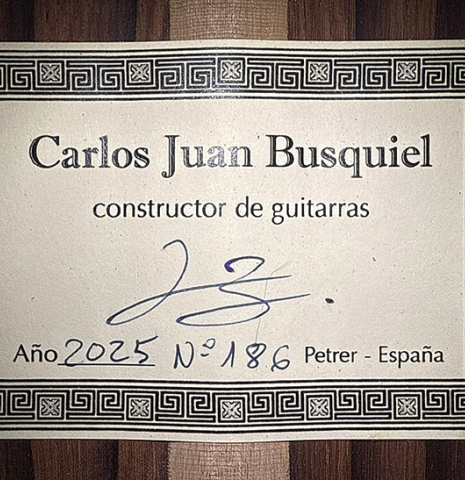 The label of a 2025 Carlos Juan Busquiel classical guitar made with cedar and African rosewood