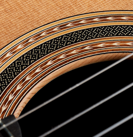 Detailed closeup of the rosette of a 2025 Carlos Juan Busquiel classical guitar made with cedar and African rosewood