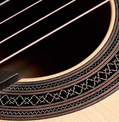 The rosette of a 2022 Carlos Juan Busquiel classical guitar made with spruce and CSA rosewood.