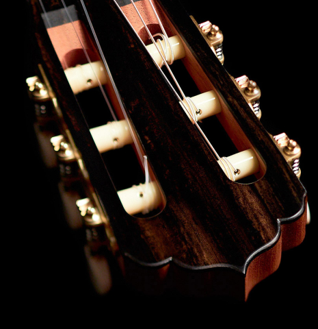 The headstock of a 2022 Carlos Juan Busquiel classical guitar made with spruce and CSA rosewood.