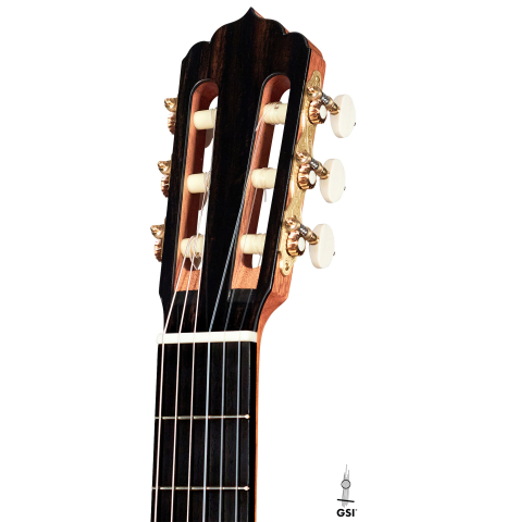 The headstock of a 2022 Carlos Juan Busquiel classical guitar made with spruce and CSA rosewood shown on a white background