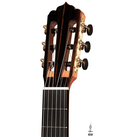 The headstock of a 2023 Carlos Juan Busquiel classical guitar made with spruce and CSA rosewood shown on a white background