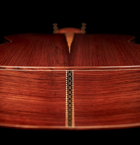 The back, binding, purfling inlays and sides at the foot of a 2023 Carlos Juan Busquiel classical guitar made with spruce and CSA rosewood.