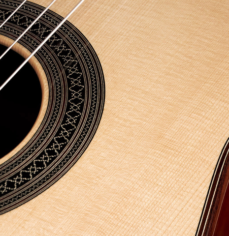 The rosette and top of a 2023 Carlos Juan Busquiel classical guitar made with spruce and CSA rosewood.