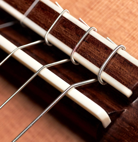 The bridge of a 2023 Carlos Juan Busquiel classical guitar made with cedar and CSA rosewood.