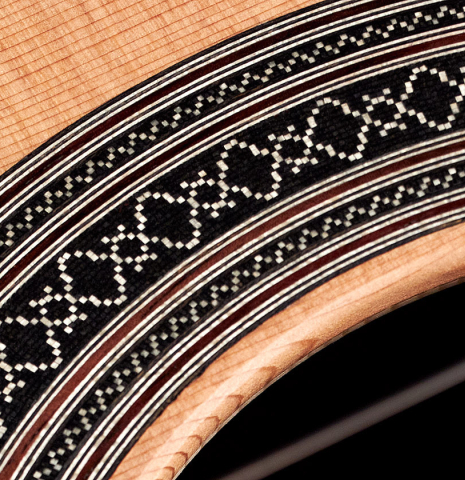 The rosette of a 2023 Carlos Juan Busquiel classical guitar made with cedar and CSA rosewood.