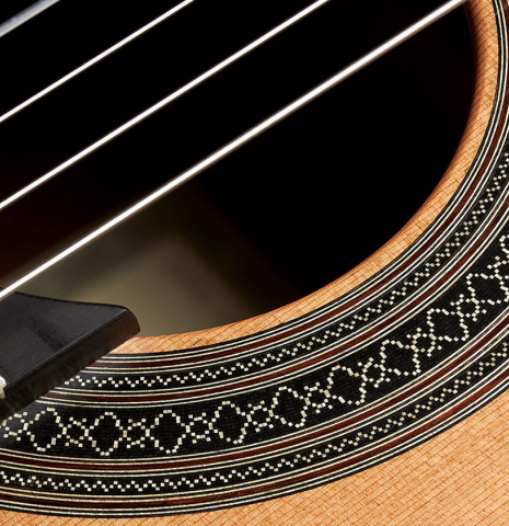 Closeup detail of the rosette of a 2024 Carlos Juan Busquiel classical guitar made with cedar and CSA rosewood