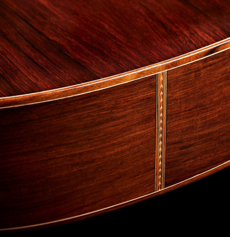 The sides at the foot of a 2024 Carlos Juan Busquiel classical guitar made with spruce and African rosewood