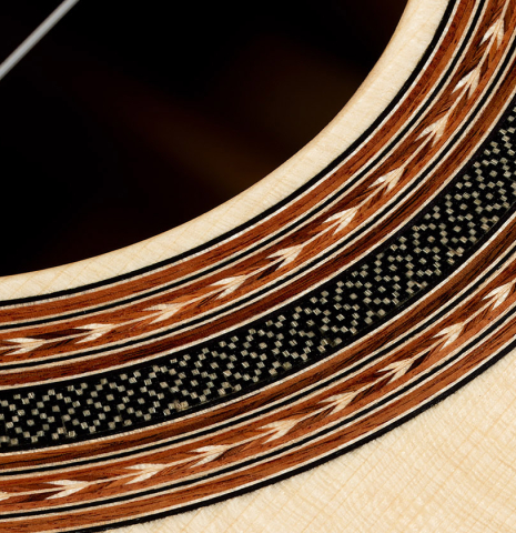 Closeup detail of the rosette of a 2024 Carlos Juan Busquiel classical guitar made with spruce and African rosewood