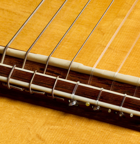 The bridge, tie-block and saddle of a 2007 Gregory Byers "7-string" classical guitar (ex John Dearman) made of spruce and CSA rosewood