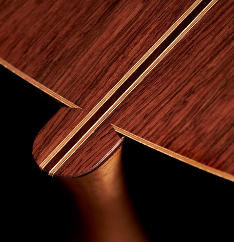 The heel of a 2022 Michael Cadiz "Torres/Romanillos" classical guitar made with spruce and African rosewood.