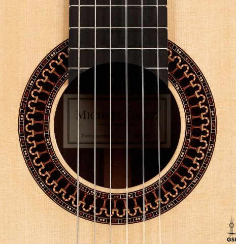 The rosette of a 2022 Michael Cadiz "Torres/Romanillos" classical guitar made with spruce and African rosewood.
