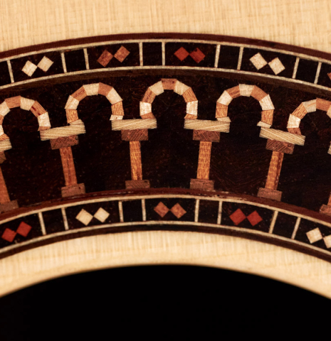 The rosette of a 2022 Michael Cadiz "Torres/Romanillos" classical guitar made with spruce and African rosewood.