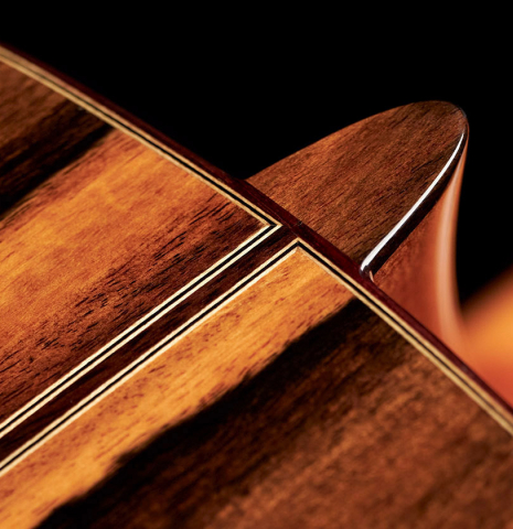 The heel of a 2023 Hermanos Camps "CL20-S" classical guitar made of spruce and exotic ebony.