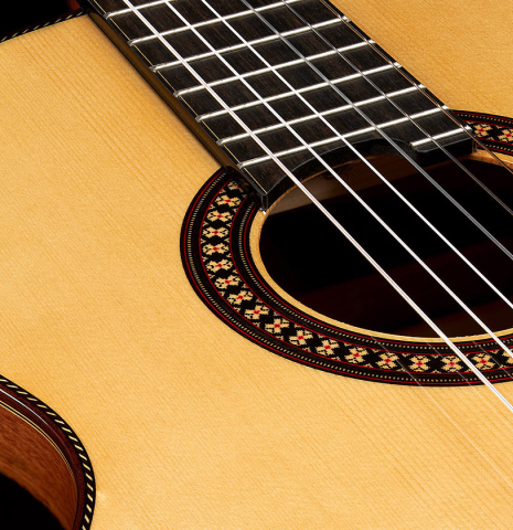 The soundboard and rosette of a 2023 Hermanos Camps "CL20-S" classical guitar made of spruce and exotic ebony