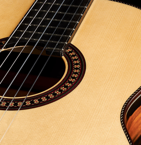 The soundboard and rosette of a 2024 Hermanos Camps "CL20-S" classical guitar made of spruce and exotic ebony