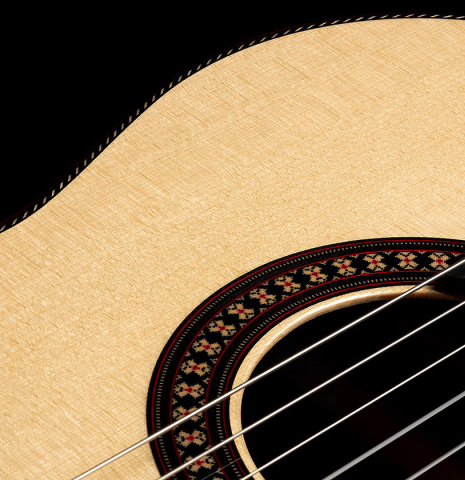 The soundboard and rosette of a 2024 Hermanos Camps "CL20-S" classical guitar made of spruce and exotic ebony